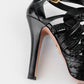 Sandalias de Tacón Prada en Piel Negra con Hebilla Dorada