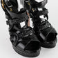 Sandalias de Tacón Prada en Piel Negra con Hebilla Dorada